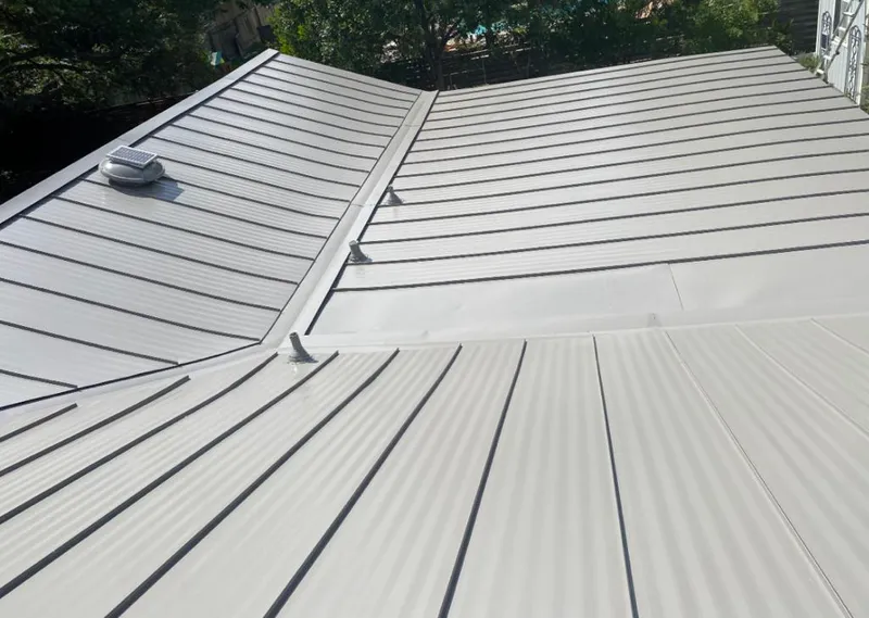 Solar attic fan installed on a metal roof for Roof Ventilation in Tahlequah